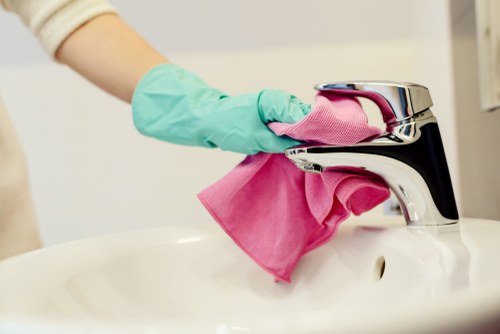 Cleaning professional following safe work practices during a domestic cleaning task
