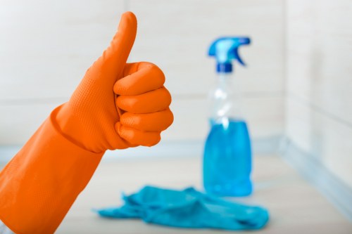 Cleaning professional wearing PPE during a safety-focused cleaning task